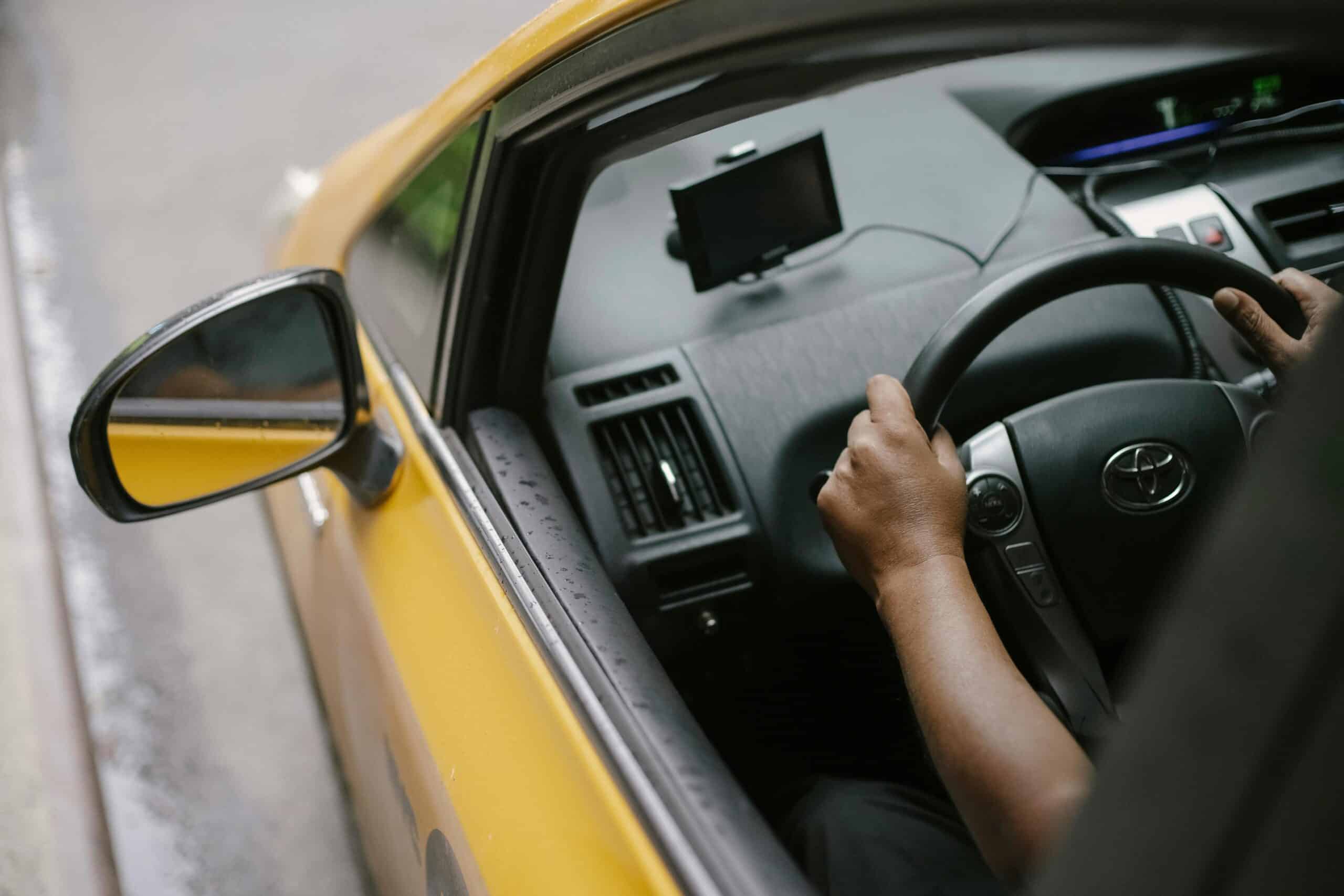 Person Driving Yellow Car
