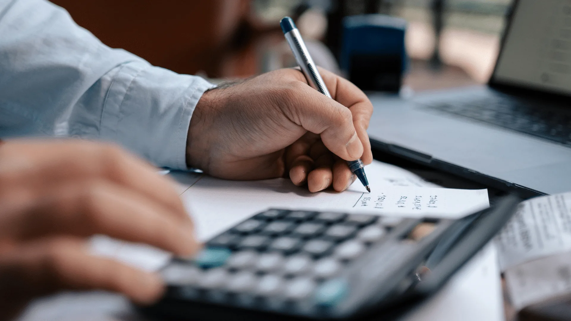 Person calculating costs at their desk