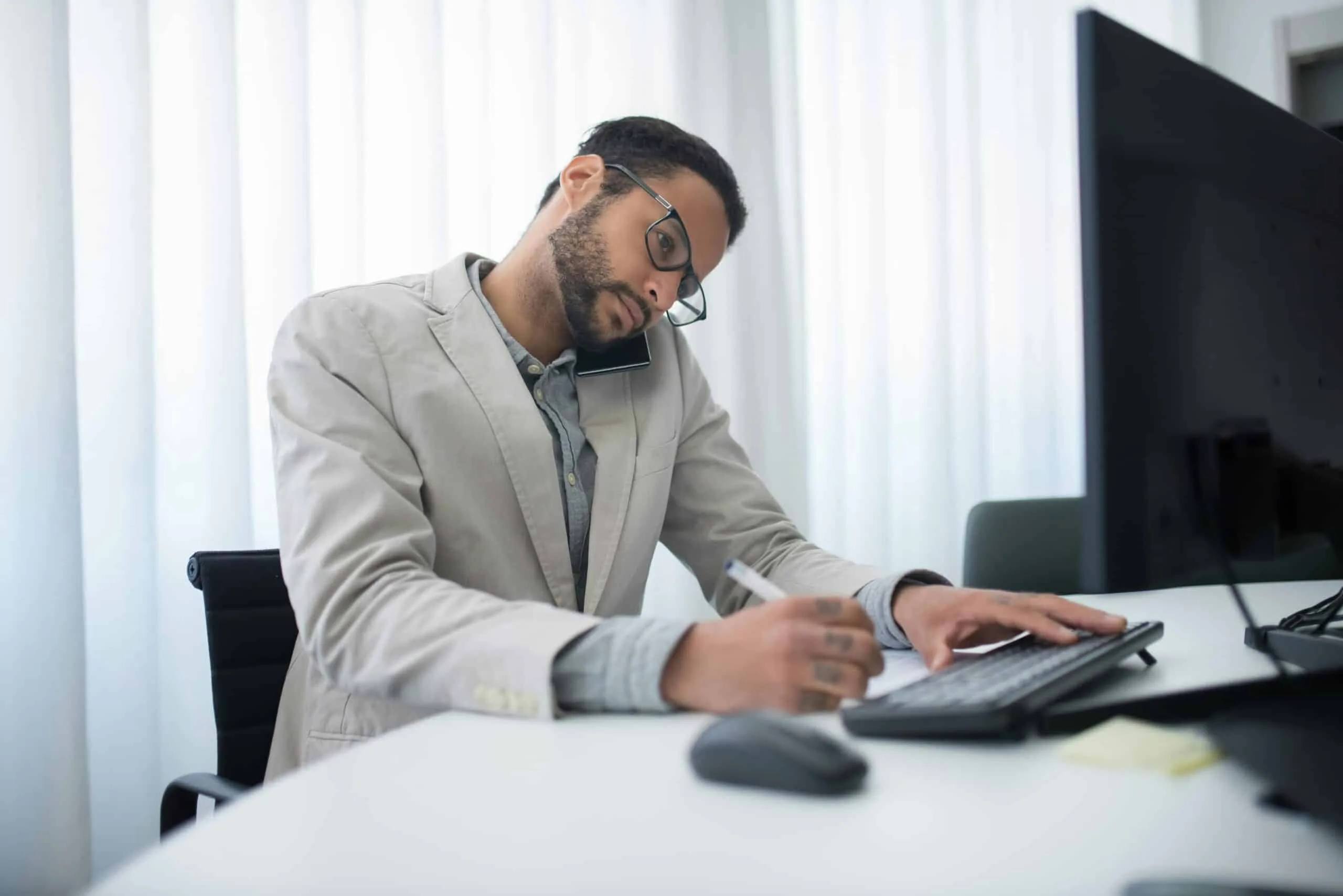 Auto dealer on the computer at his desk