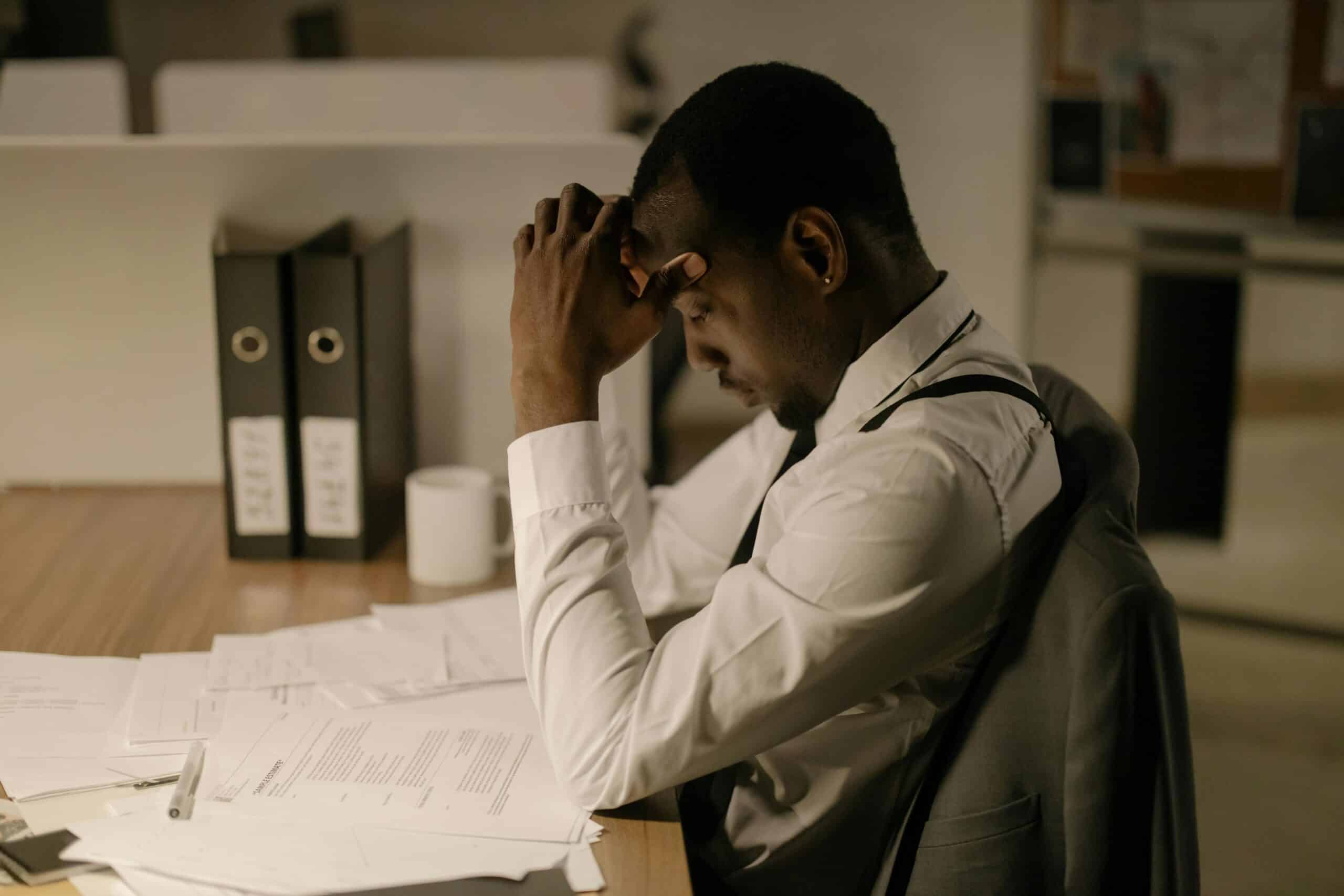 Auto dealer sitting at a desk in front of loan papers