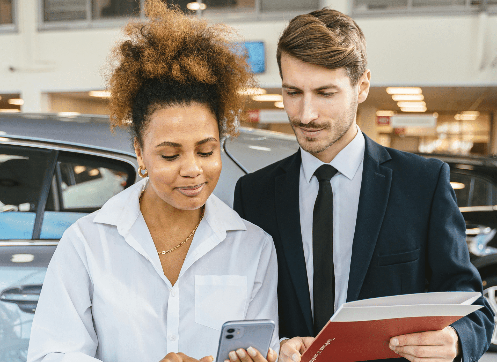 Dealer and customer closing a car sale
