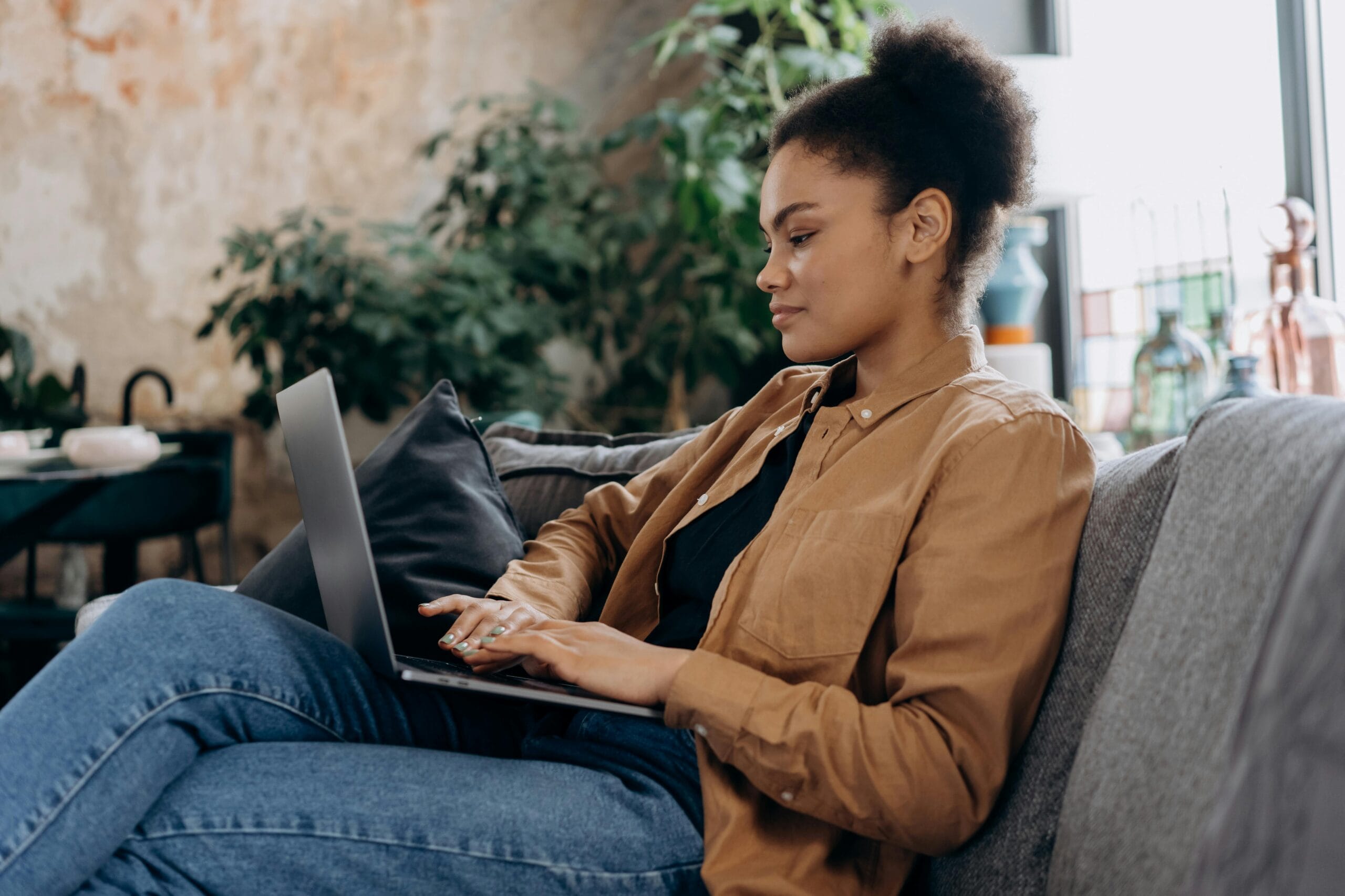 Woman sitting on the couch with her laptop
