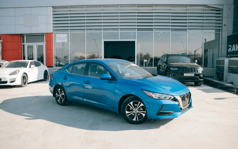 Blue Nissan in a car sales lot